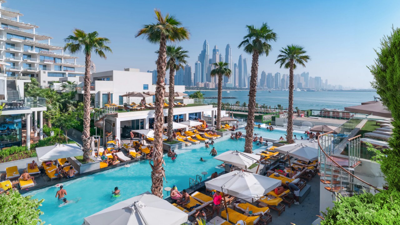 The Social Pool with sun loungers and Dubai Marina views at FIVE Palm Jumeirah