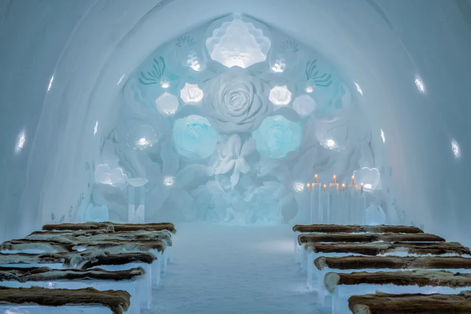 The annually hand-carved ice ceremony hall at Icehotel in Jukkasjärvi, a unique and ephemeral wedding venue