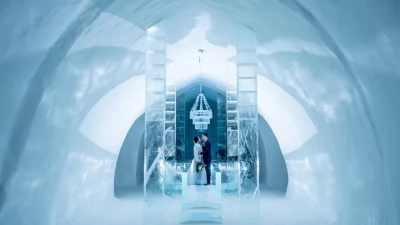 A couple celebrates their Icehotel wedding under the magical aurora borealis in Swedish Lapland