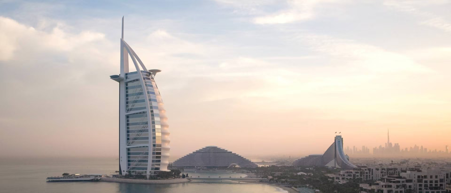 Jumeirah Burj Al Arab's iconic sail-shaped exterior at sunset, Dubai