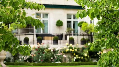 Shangri-La Paris's lush gardens and historic building, highlighting its commitment to integrating nature and sustainability within its luxury hospitality.