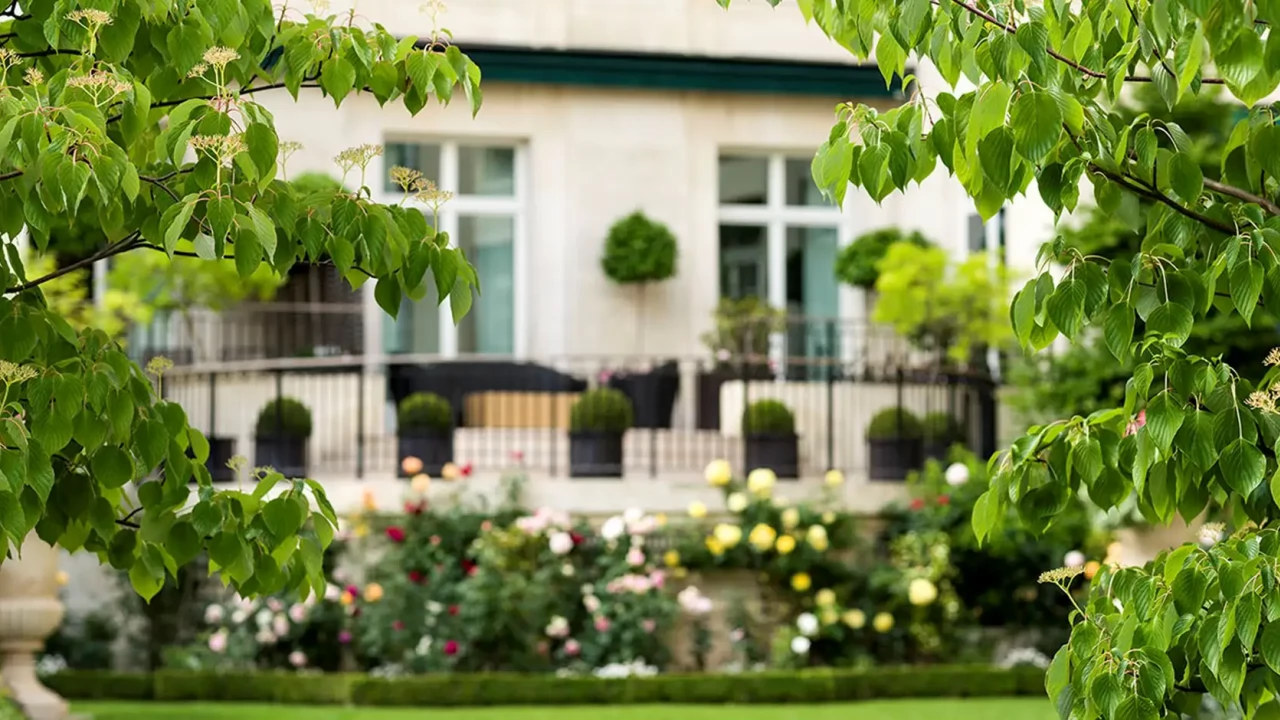 Shangri-La Paris's lush gardens and historic building, highlighting its commitment to integrating nature and sustainability within its luxury hospitality.