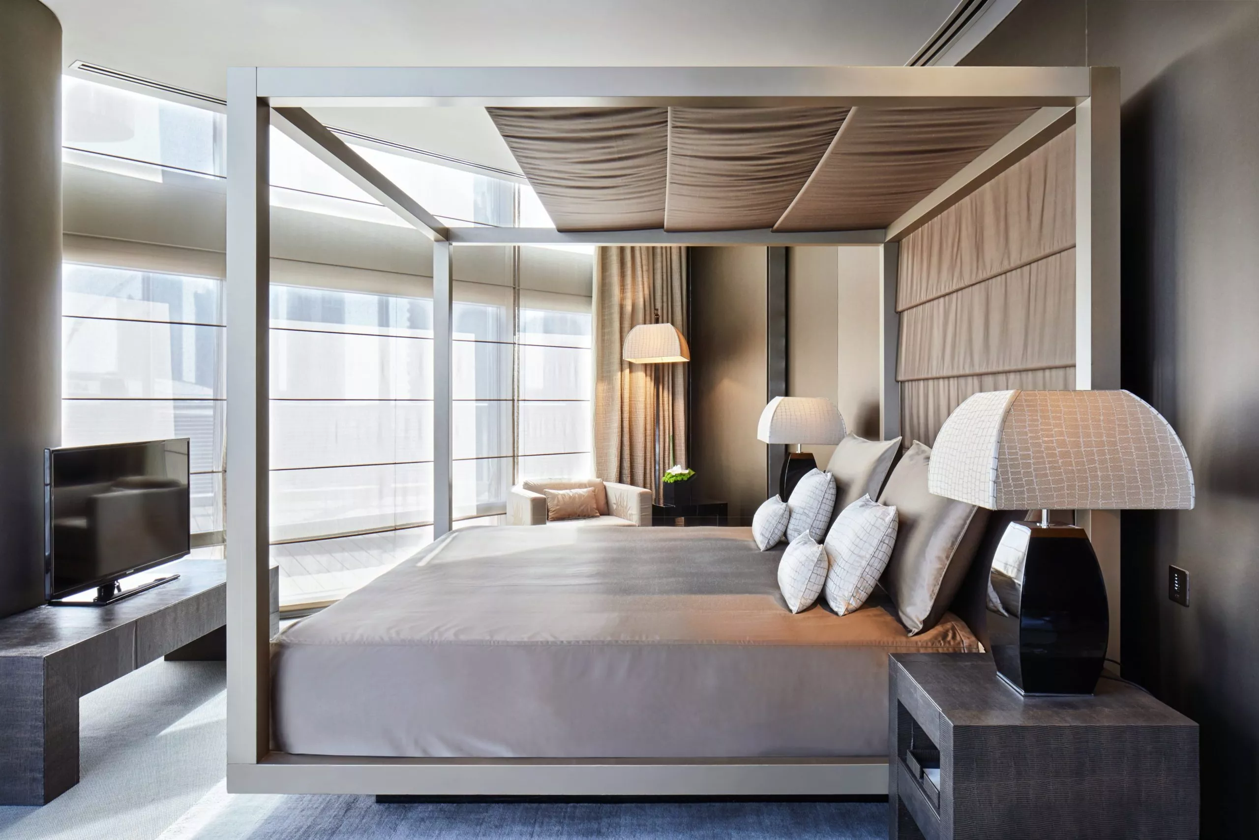 The spacious and elegant bedroom of the Armani Ambassador Suite, featuring custom Armani/Casa furnishings and luxurious decor.