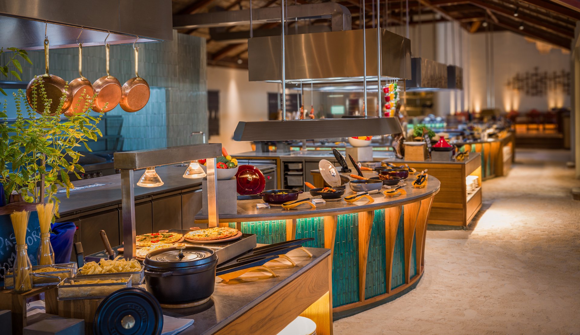 Interior view of Atoll Market restaurant with live cooking stations, Conrad Maldives.