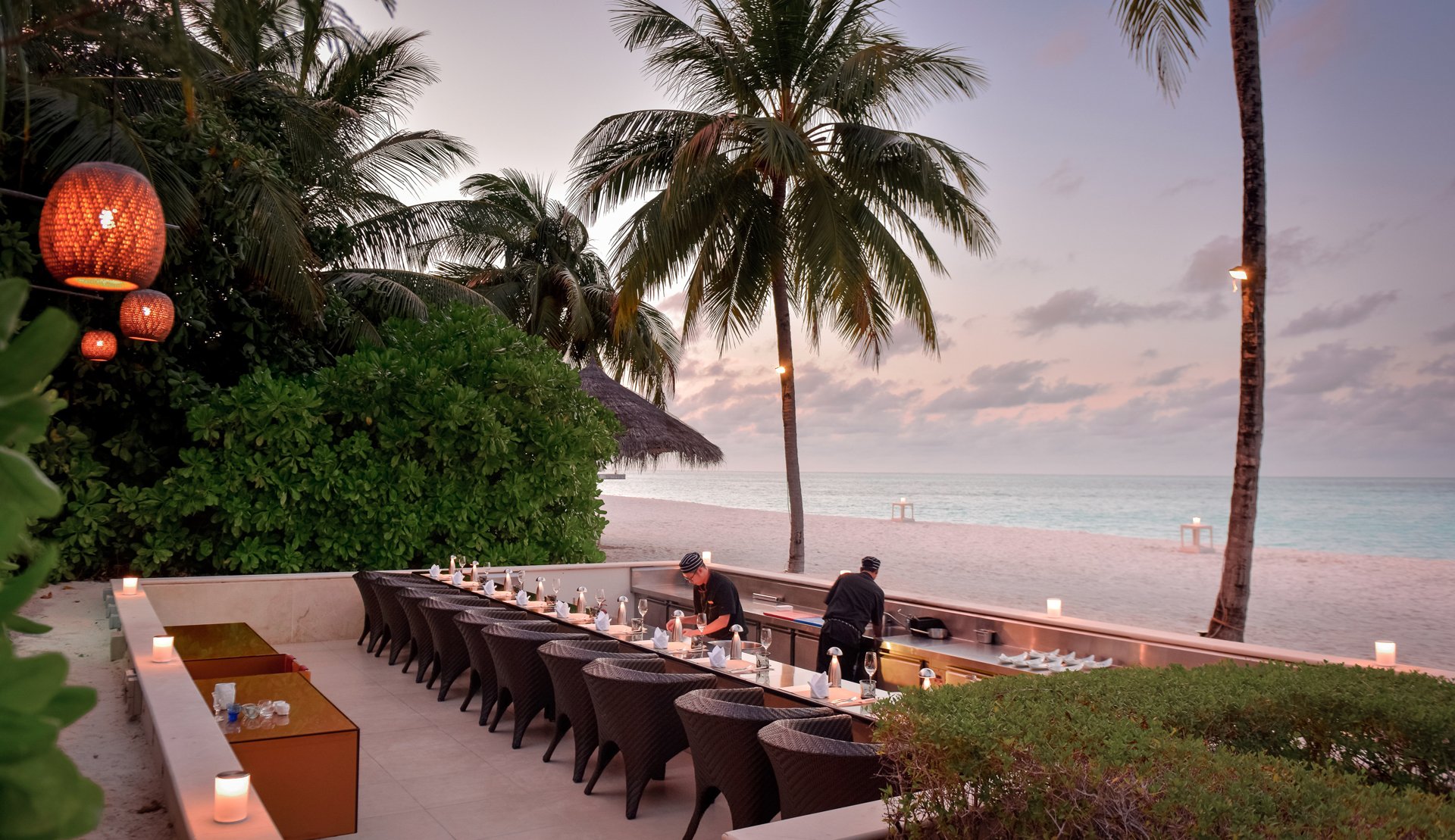 Koko Grill restaurant at dusk with evening setup, Conrad Maldives.