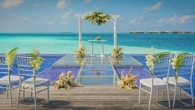 Quiet Zone Pool wedding ceremony setup over the water at Conrad Maldives.