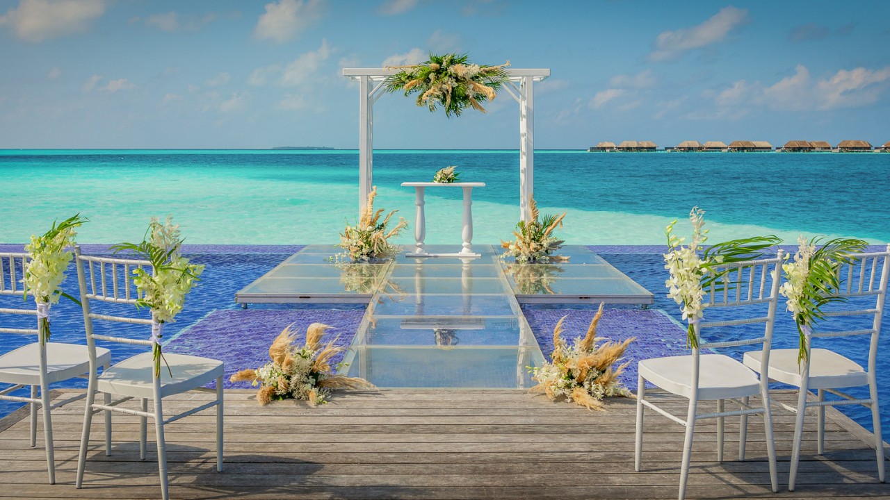 Quiet Zone Pool wedding ceremony setup over the water at Conrad Maldives.