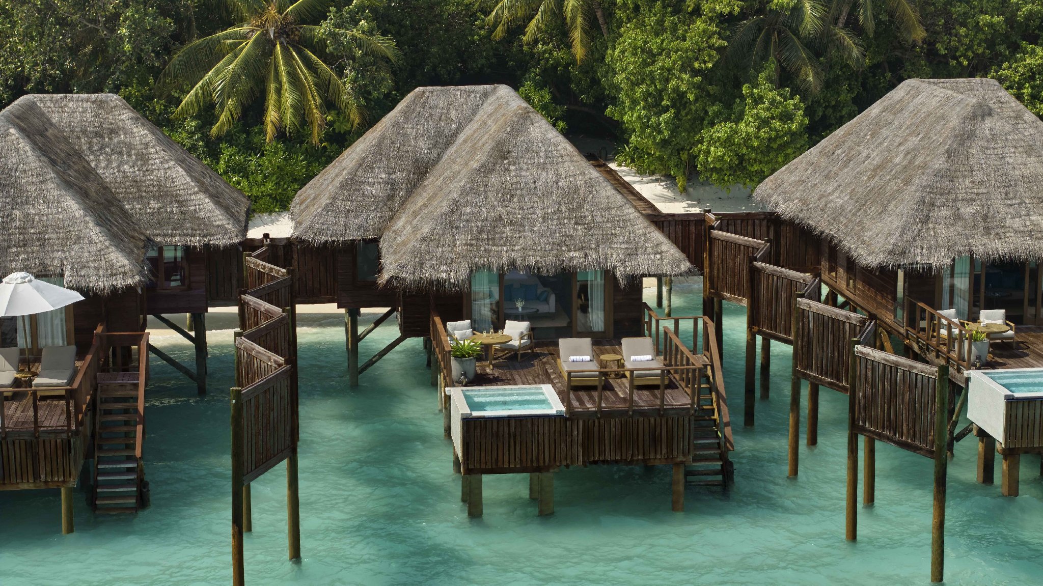 Aerial view of Sunrise Water Villas over the crystal clear lagoon at Conrad Maldives.