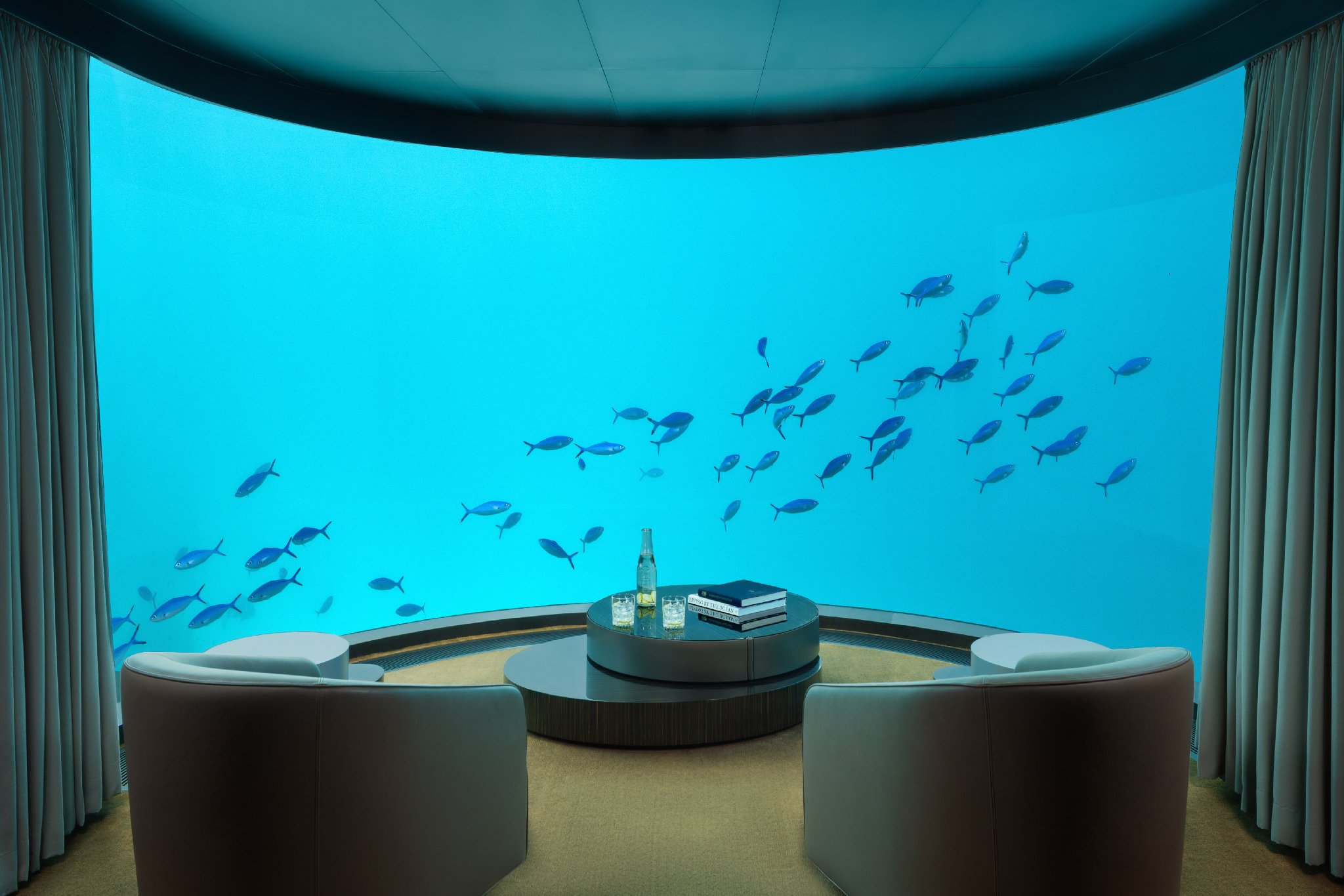 Undersea living area with panoramic ocean views in The Muraka at Conrad Maldives.