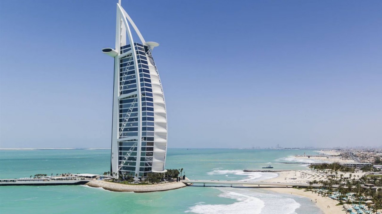 A breathtaking aerial perspective of the Jumeirah Burj Al Arab and its surrounding waters.