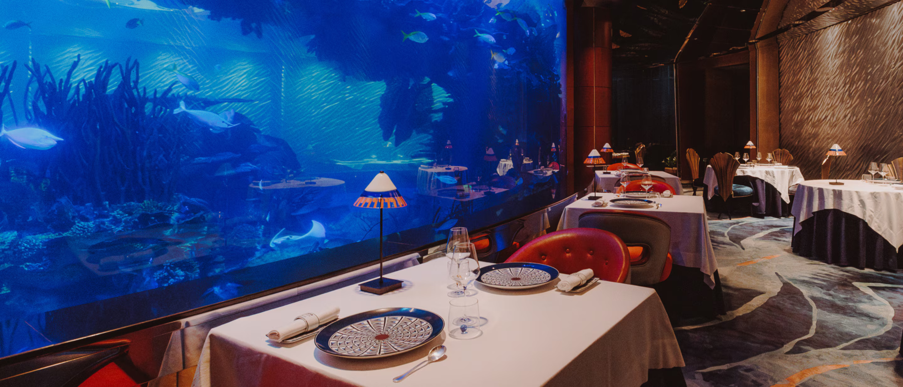 The stunning central aquarium at Ristorante L'Olivo at Al Mahara, offering a unique underwater ambiance.