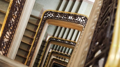 The elegant, seemingly endless staircase at Le Meurice, Paris, symbolizing the hotel's timeless and artistic allure.