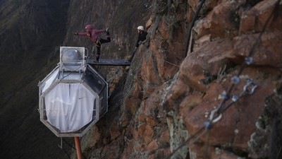 Two happy guests having just arrived at their Skylodge Adventure Suites capsule after an exhilarating climb via Via Ferrata or zipline.