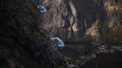 Wide-angle view of two Skylodge capsules suspended 400 meters high with the breathtaking Sacred Valley landscape stretching out behind them.