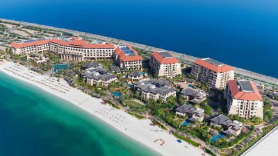 An aerial view of the resort showing its extensive pools and beachfront on the Palm Jumeirah.