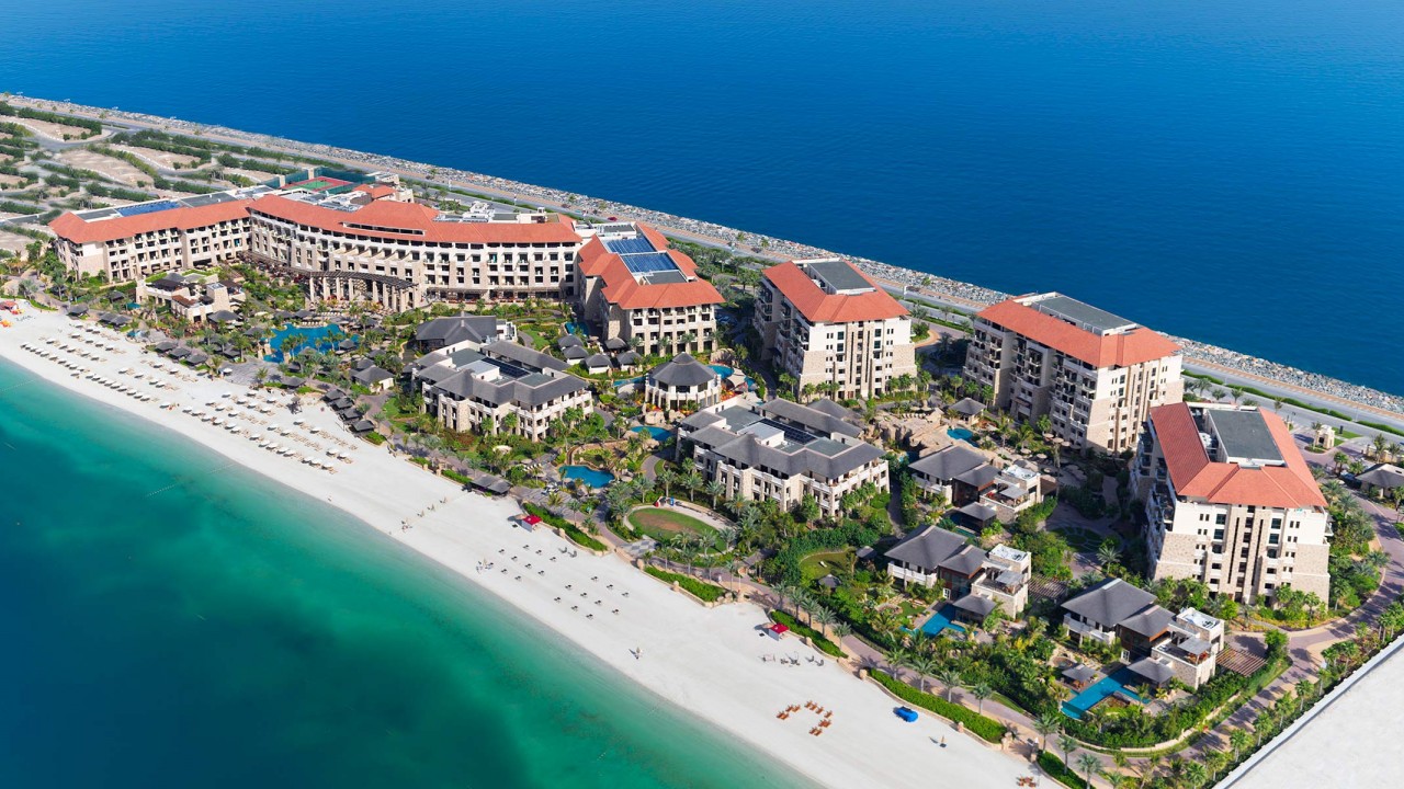 An aerial view of the resort showing its extensive pools and beachfront on the Palm Jumeirah.