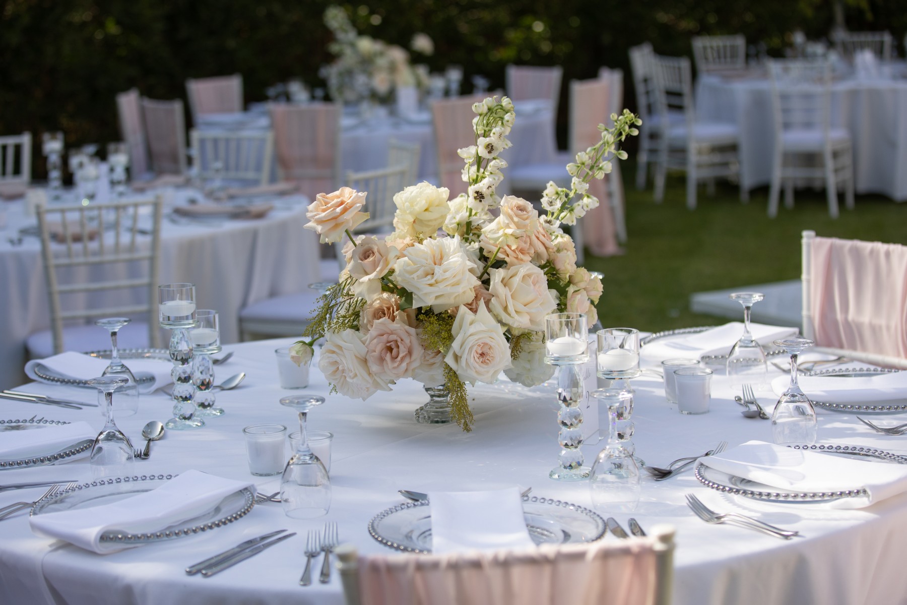 An elegantly decorated table setup for a garden wedding reception.