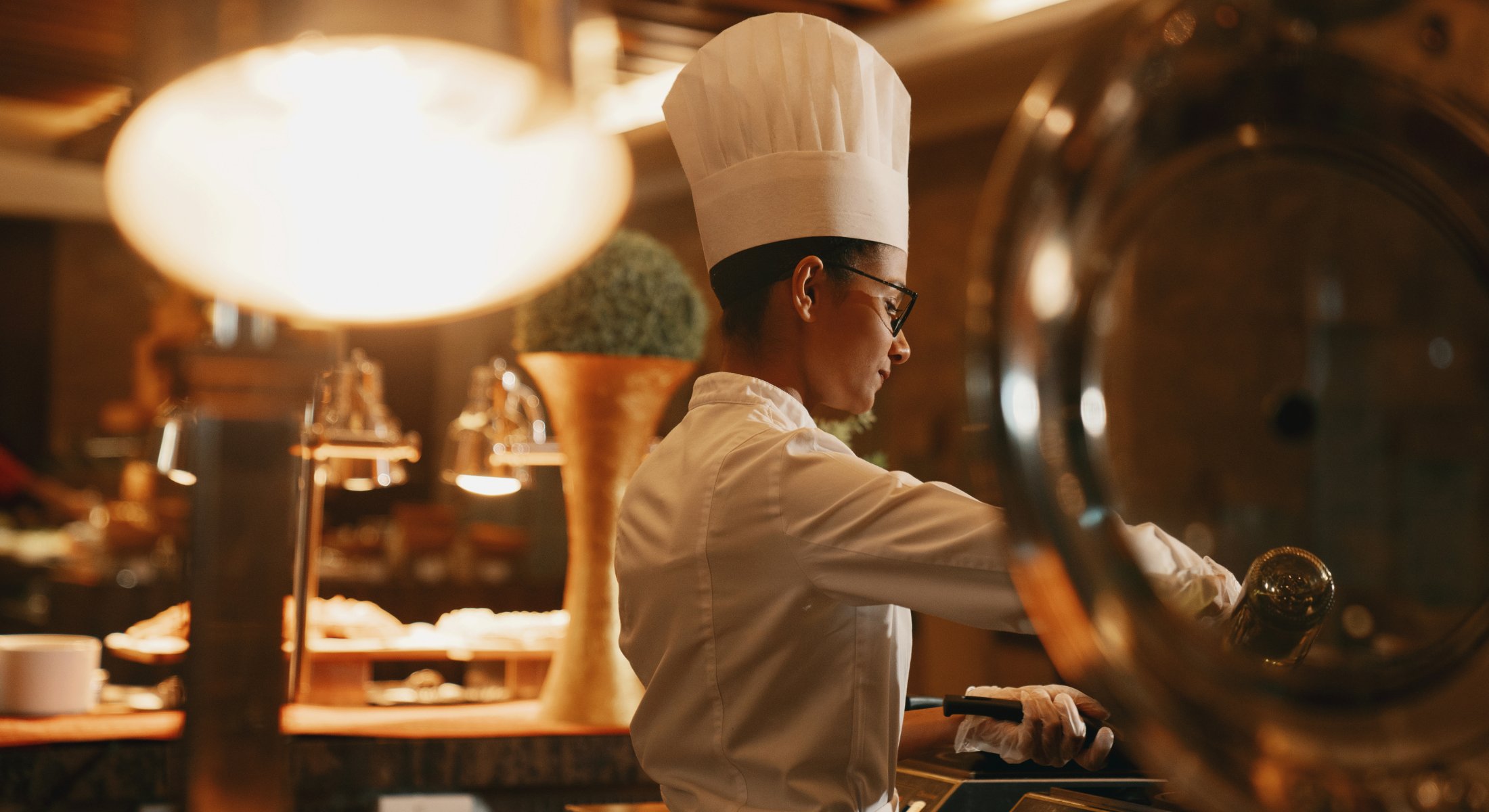 A chef prepares a dish at a live cooking station in Manava, the international buffet restaurant.