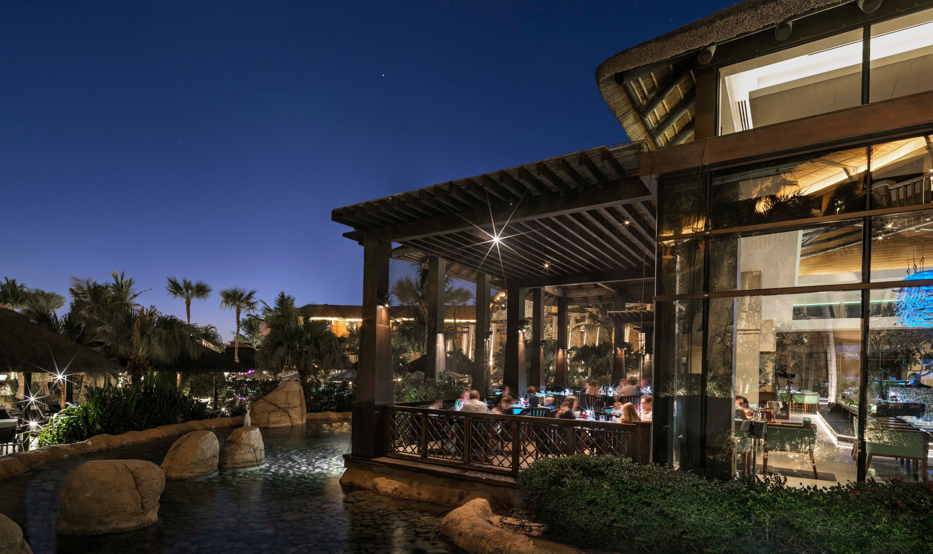 The exterior of Moana seafood restaurant at sunset, featuring Pagoda-style seating.