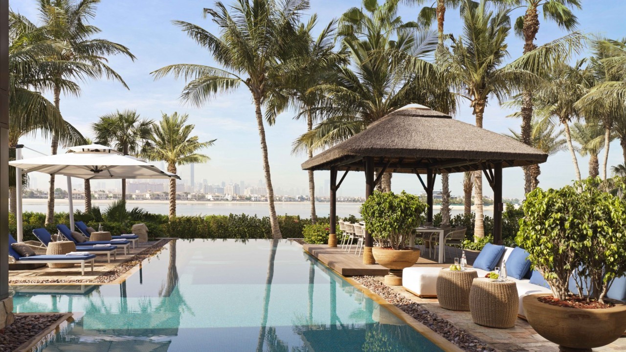 The private pool and terrace area of a Riviera Villa, surrounded by greenery.