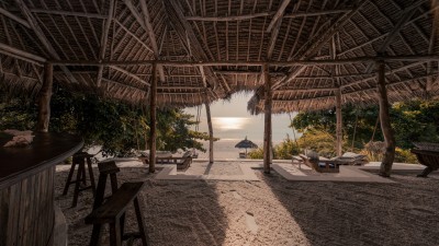 The open-air Beach Bar at The Manta Resort, offering direct views of the ocean and a relaxed setting for drinks and snacks.