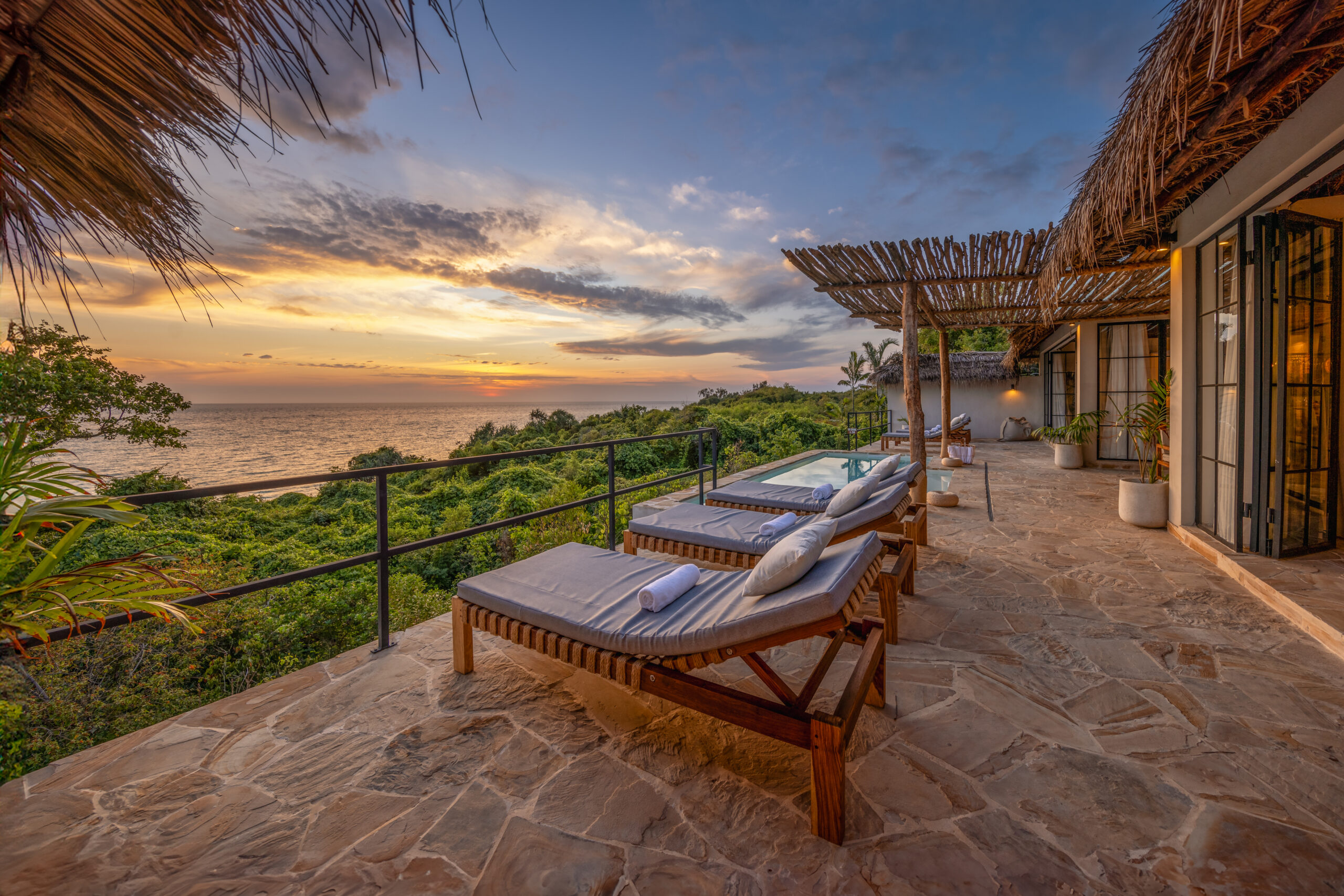 Exterior of a private Oceanview Villa at The Manta Resort, featuring a wooden deck and plunge pool with panoramic Pemba Channel views.