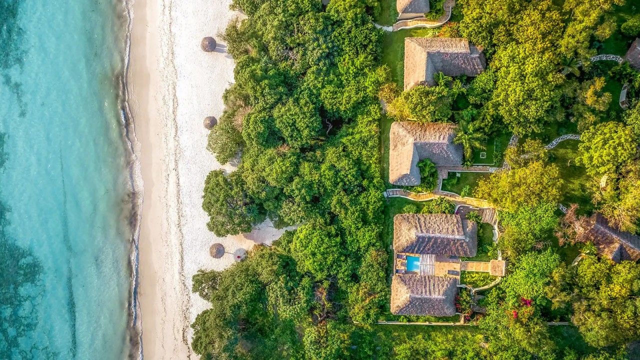 Aerial drone shot of The Oceanview Villas at The Manta Resort, nestled in lush greenery with panoramic views of the Pemba Channel.
