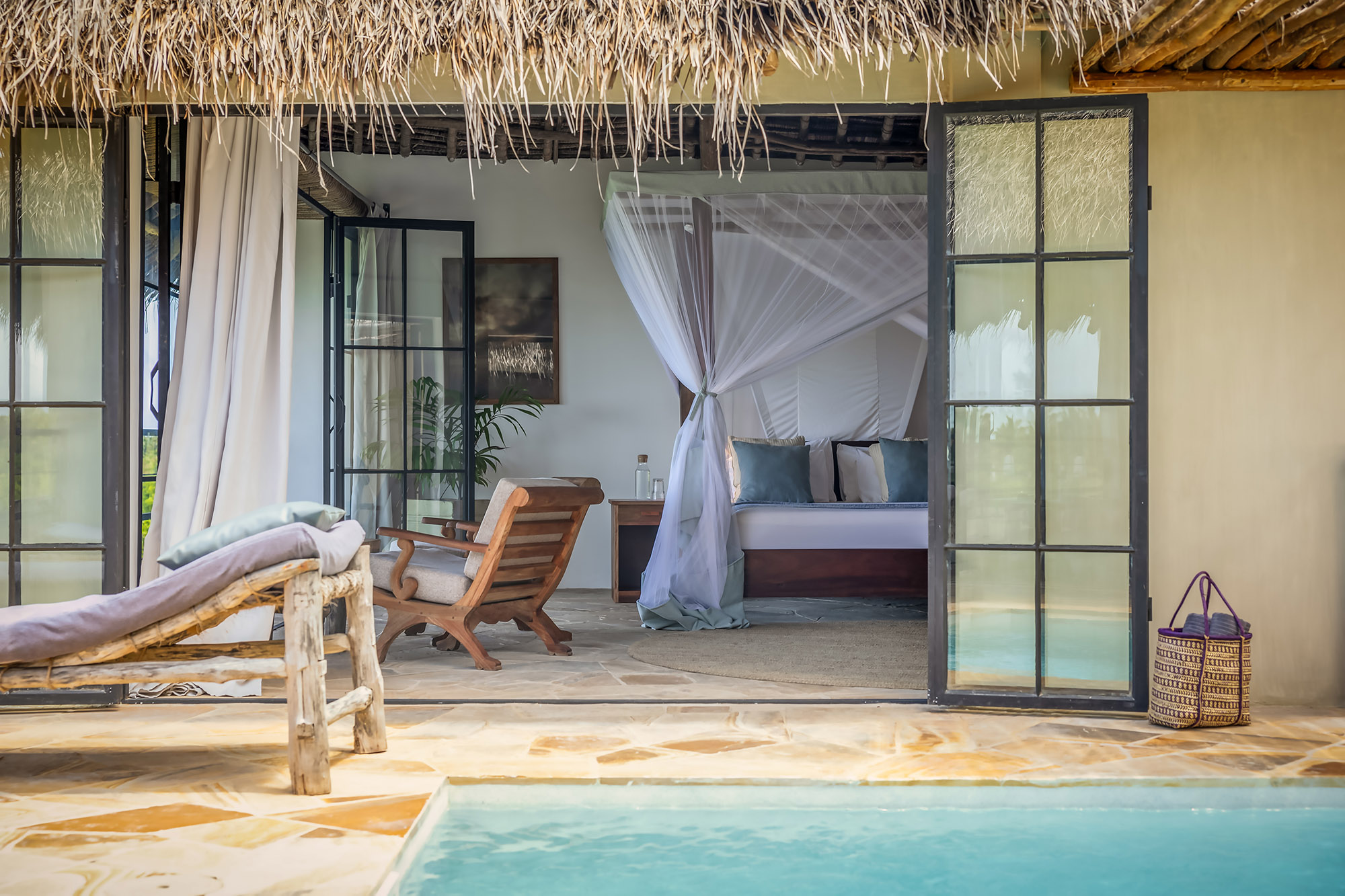 Spacious interior of the Seafront Family Villa at The Manta Resort, with direct access to the ocean and natural design elements.