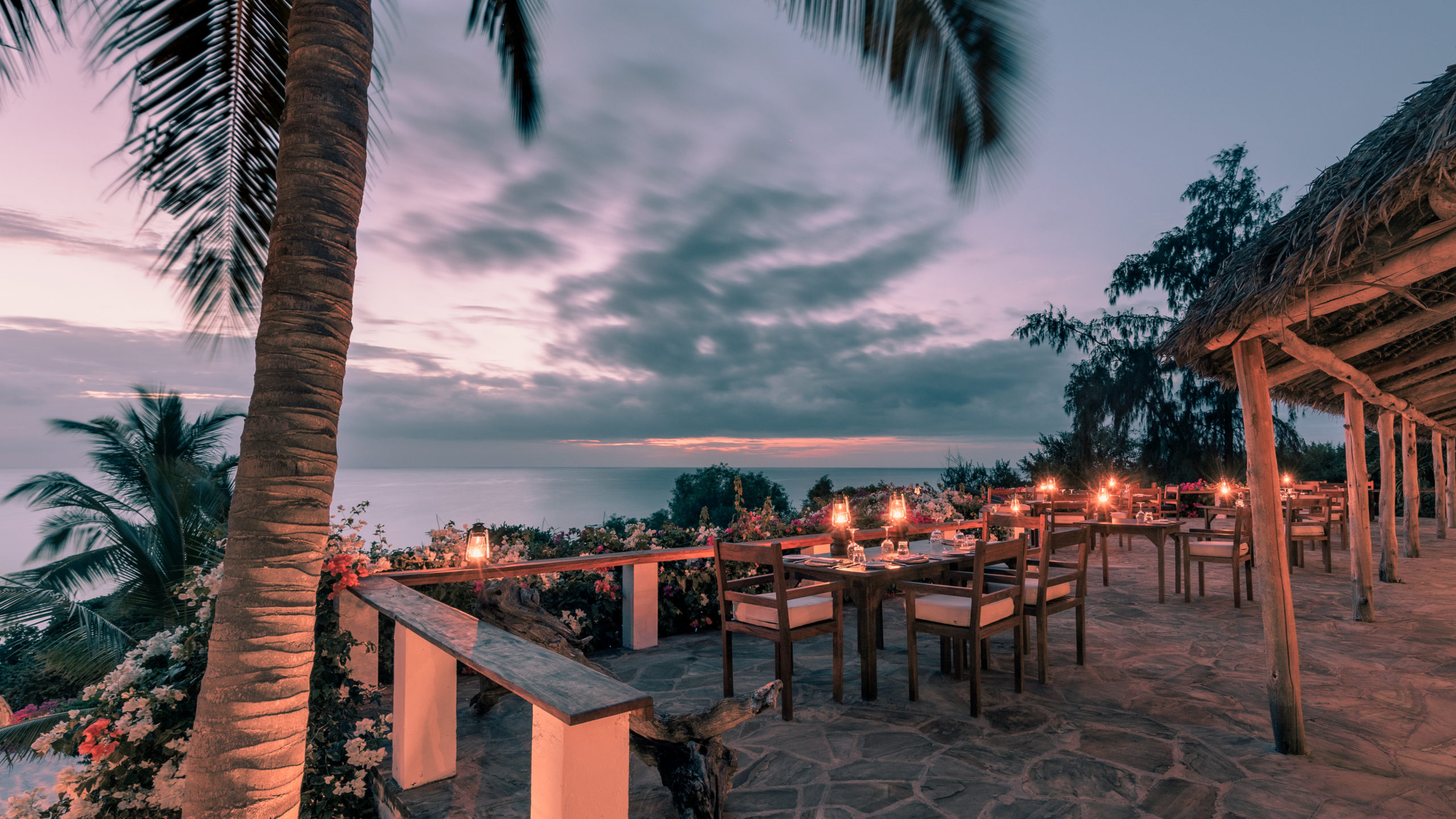 The Seaview Restaurant at The Manta Resort during sunset, offering al fresco dining with stunning views of the Pemba Channel.