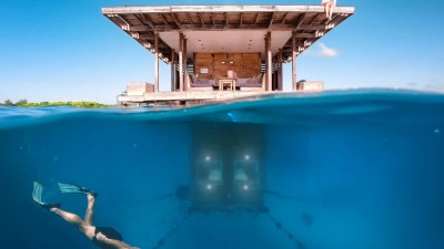 The three-level structure of The Underwater Room at The Manta Resort, showing the submerged bedroom and the sea-level platform.