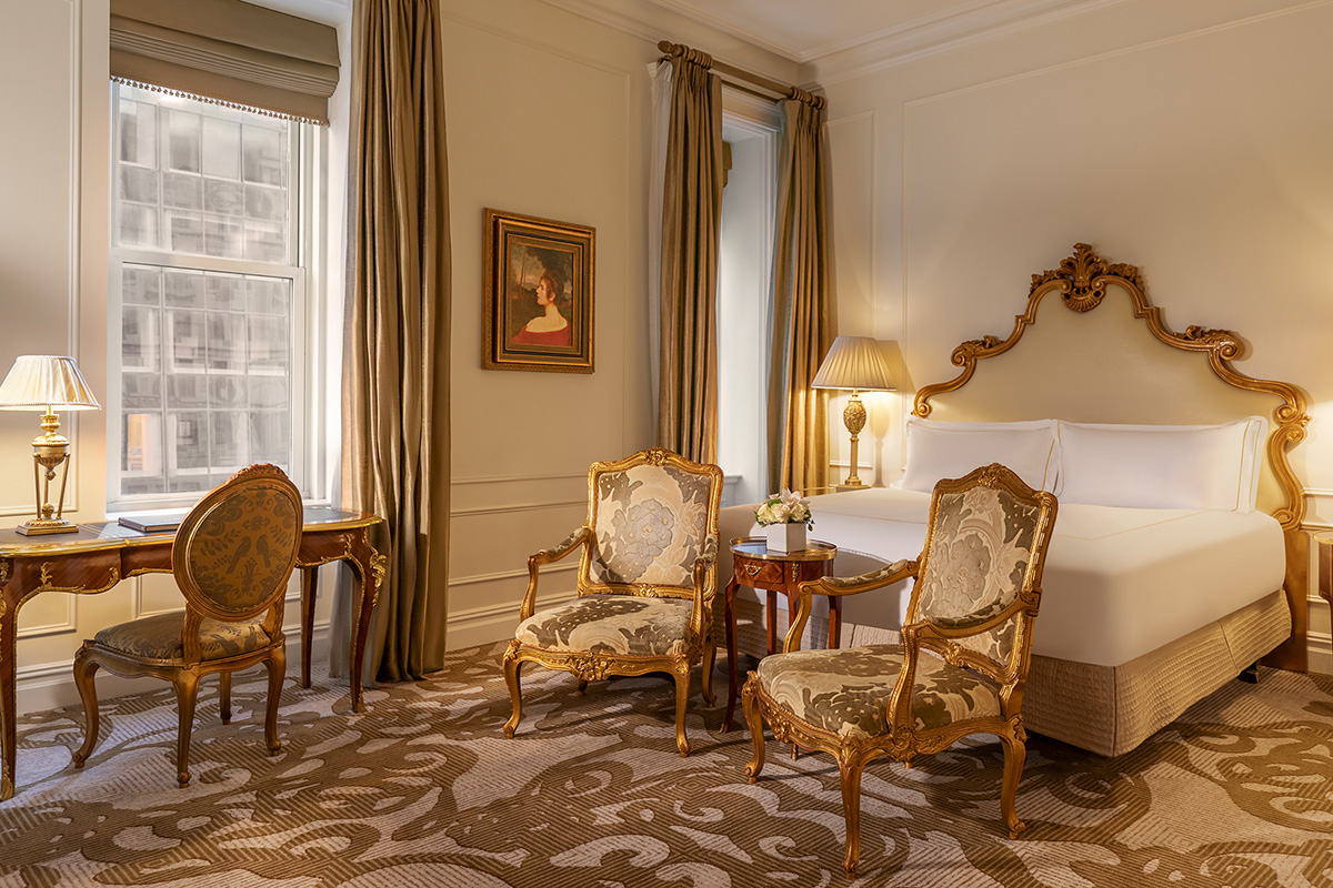 A Deluxe King room at The Plaza Hotel, showcasing spacious elegance and classic design.