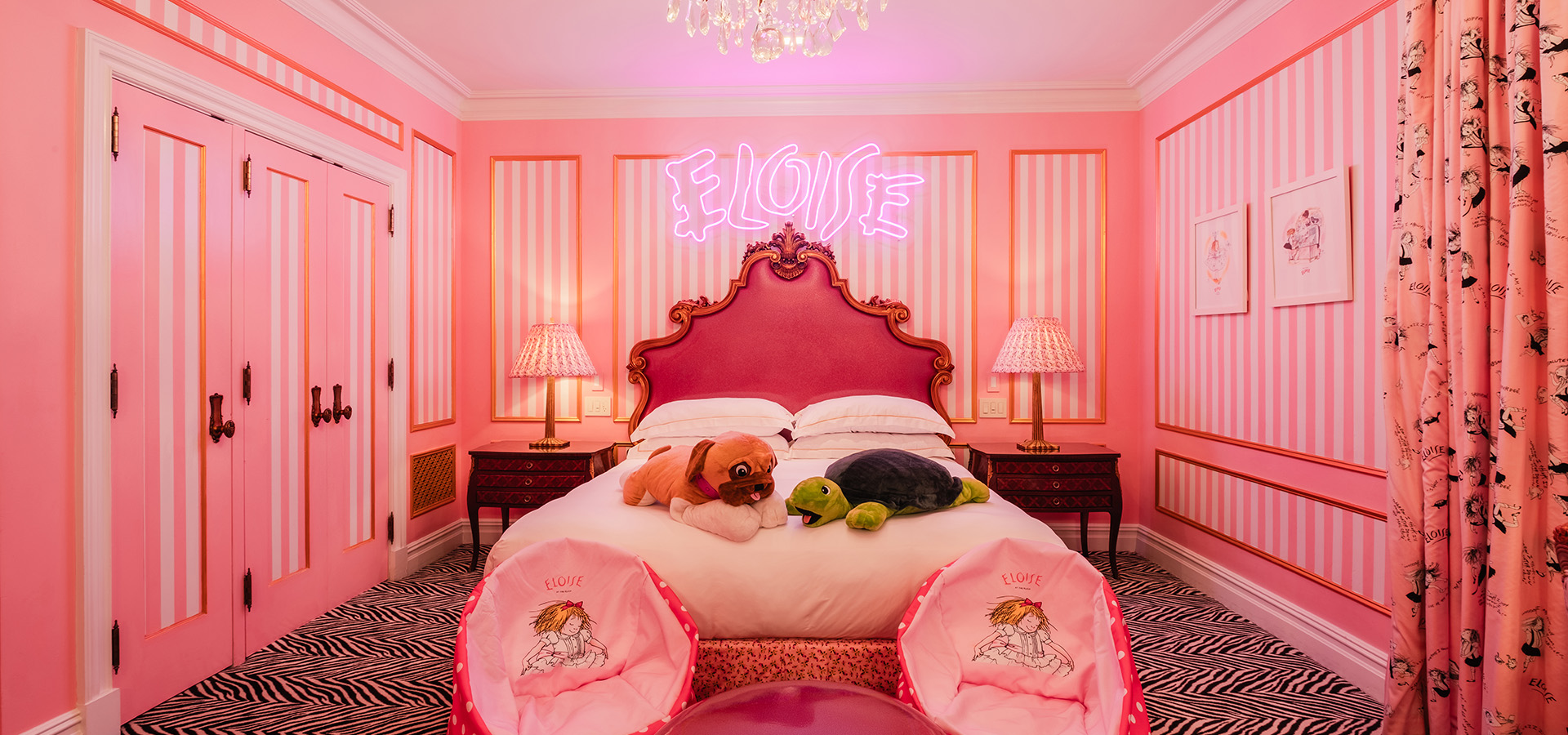 The whimsical Eloise One Bedroom King suite, designed with pink and white themes for young fans.