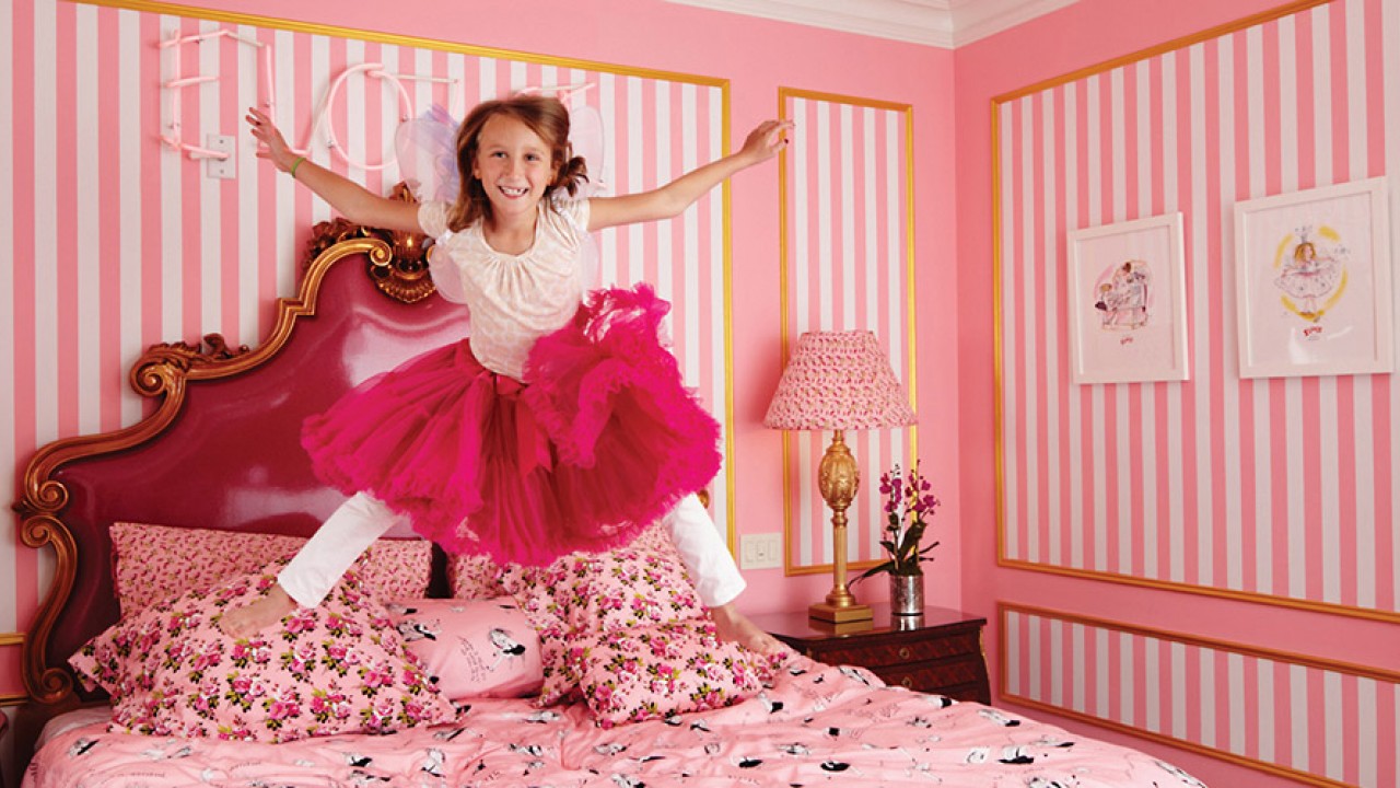 The playful Eloise Suite bedroom, designed with a pink theme and custom decor for children.