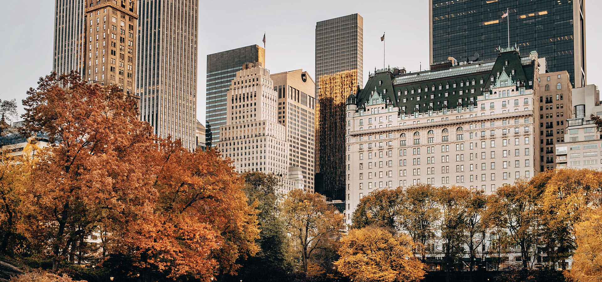 The Plaza Hotel's historic facade adorned with autumn foliage in New York City.