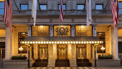 The iconic Plaza Hotel exterior at night, illuminated on Fifth Avenue and Central Park South.