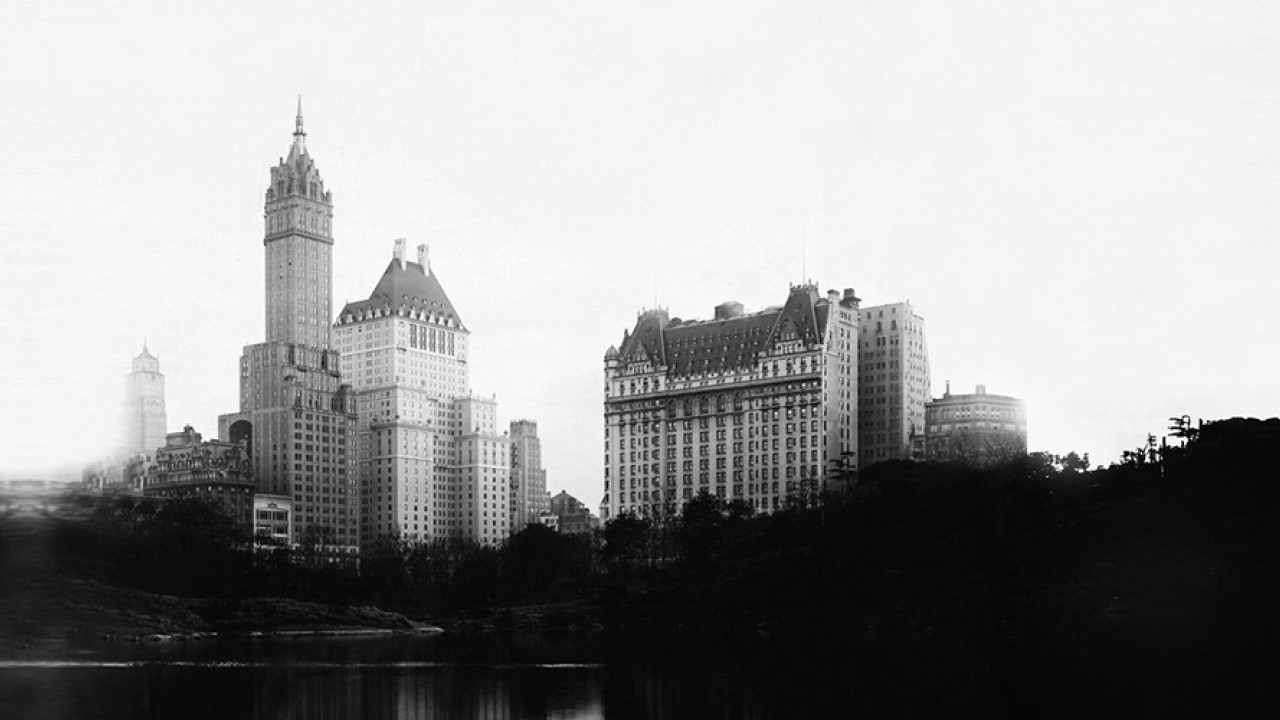 A historic black and white photo of The Plaza Hotel, reflecting its long-standing legacy in NYC.