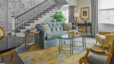 The luxurious living room in the Penthouse One Bedroom Suite, with duplex styling and terrace access.