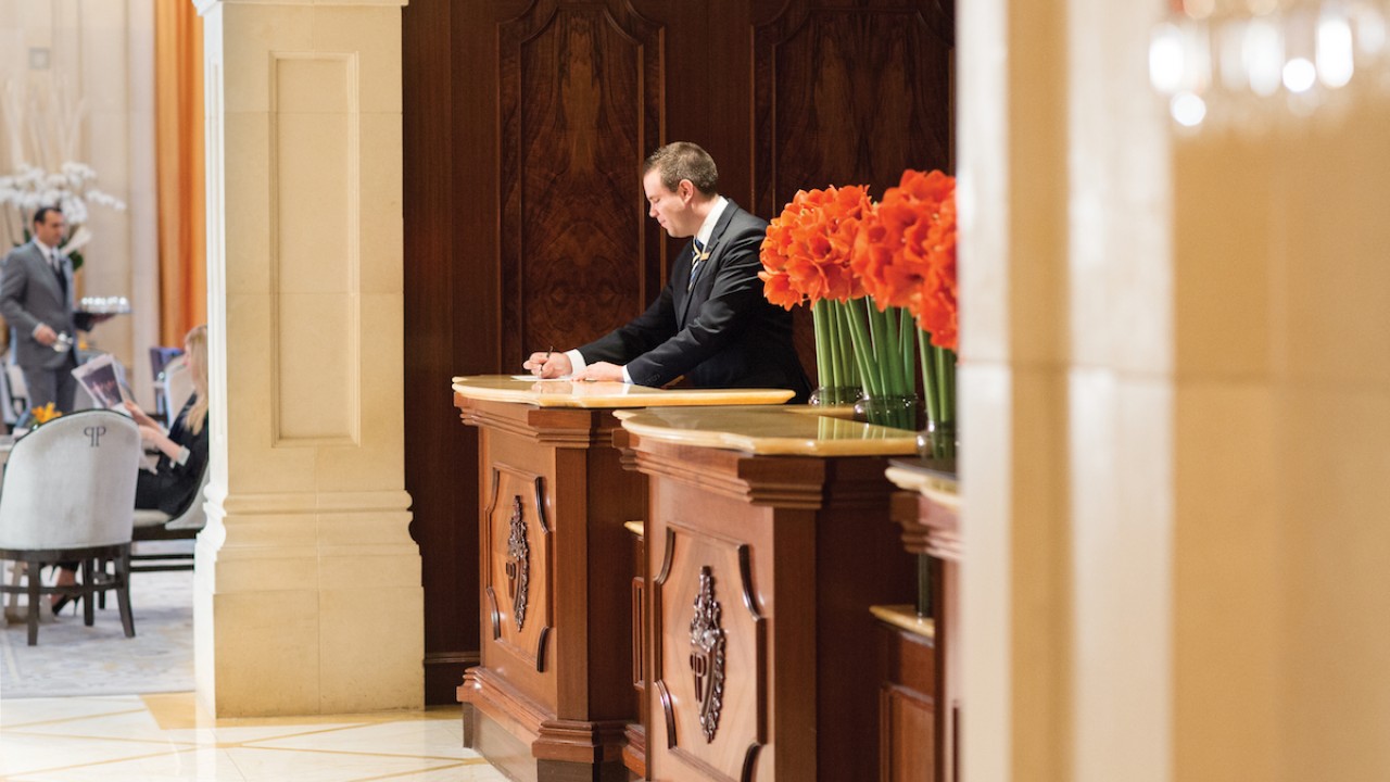 The grand reception desk at The Plaza Hotel, offering impeccable service to guests.
