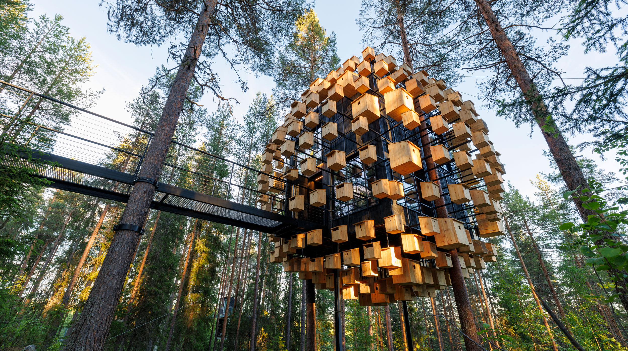 The Biosphere treehouse at Treehotel, designed by BIG, with a facade covered in bird houses for sustainability.