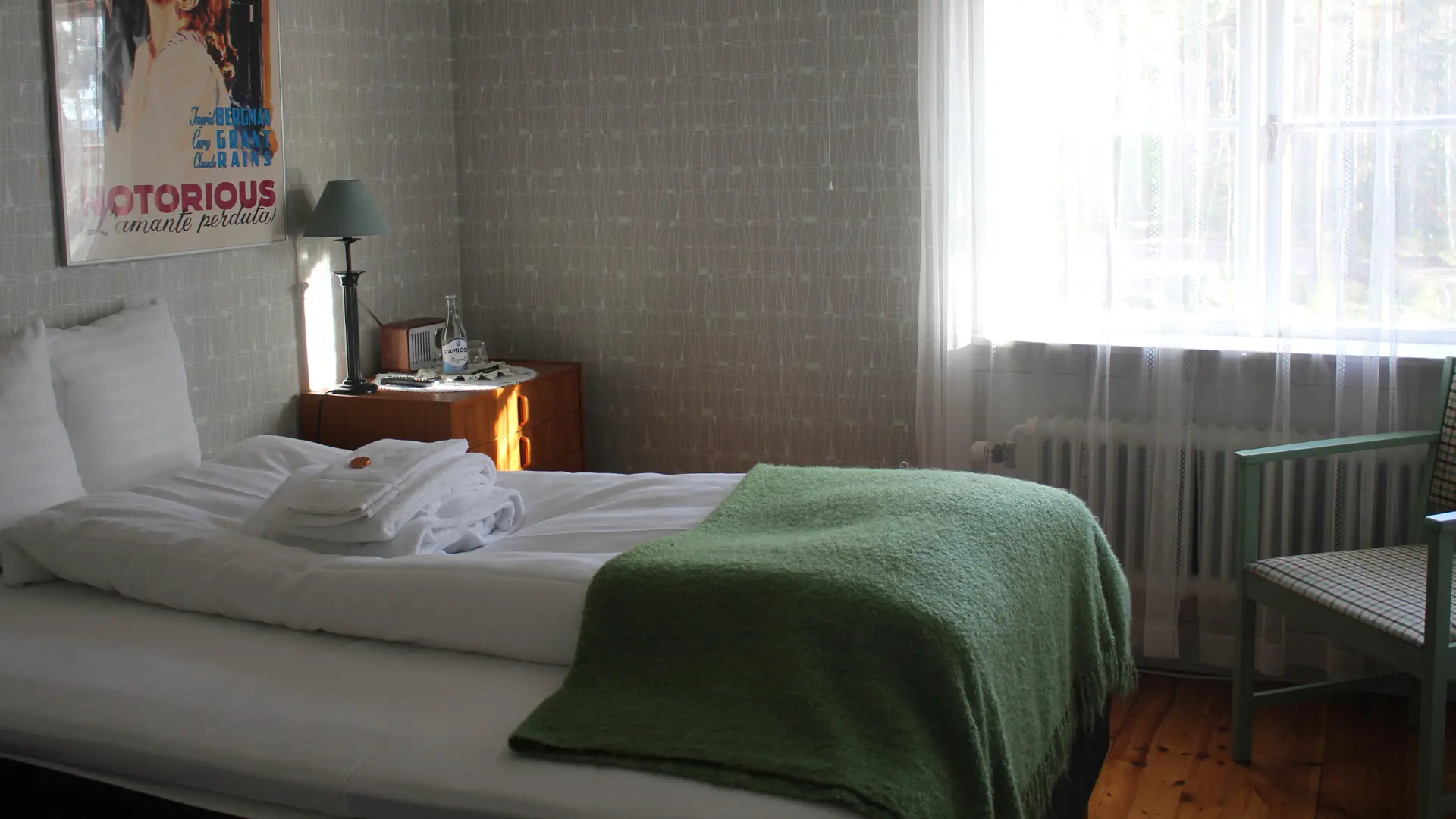 Warm and rustic interior of the Guesthouse at Treehotel, featuring traditional Swedish decor and a cozy fireplace.