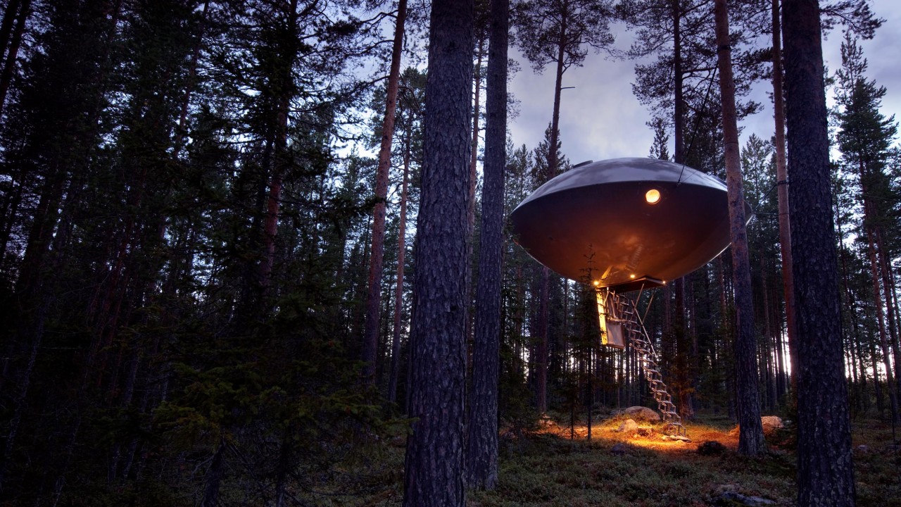 The UFO treehouse at Treehotel Sweden, a suspended spherical room offering a unique and playful stay in the forest.