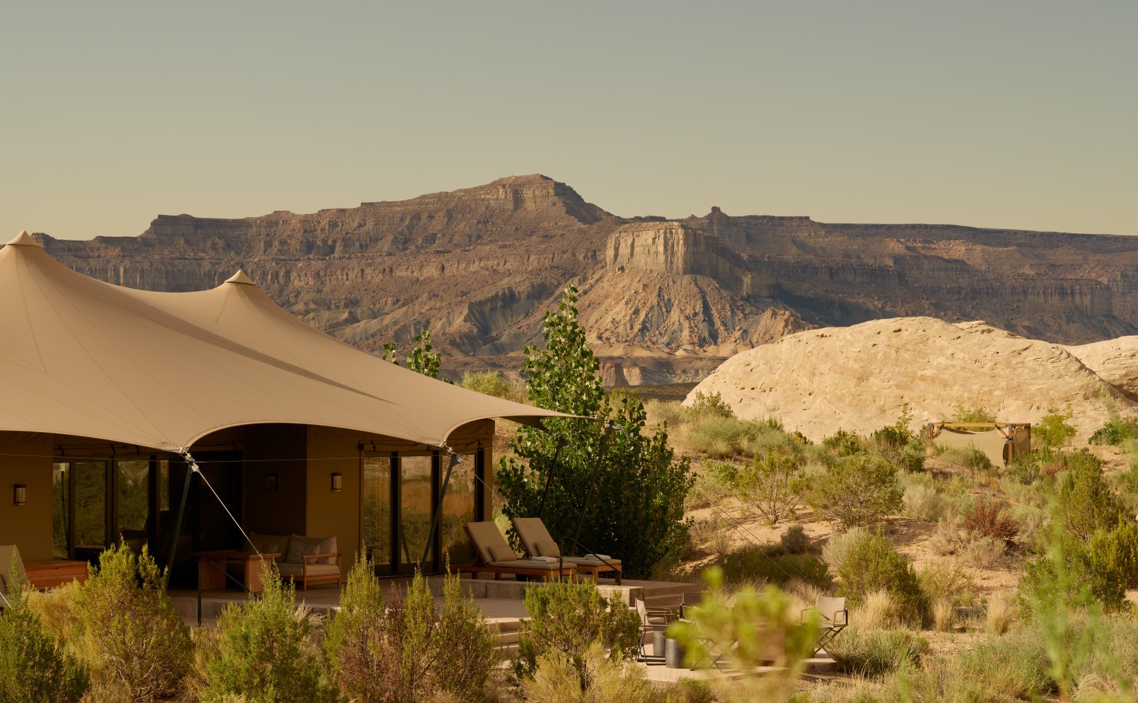 A peaceful view of Camp Sarika, a luxury desert retreat surrounded by rust-colored sands.