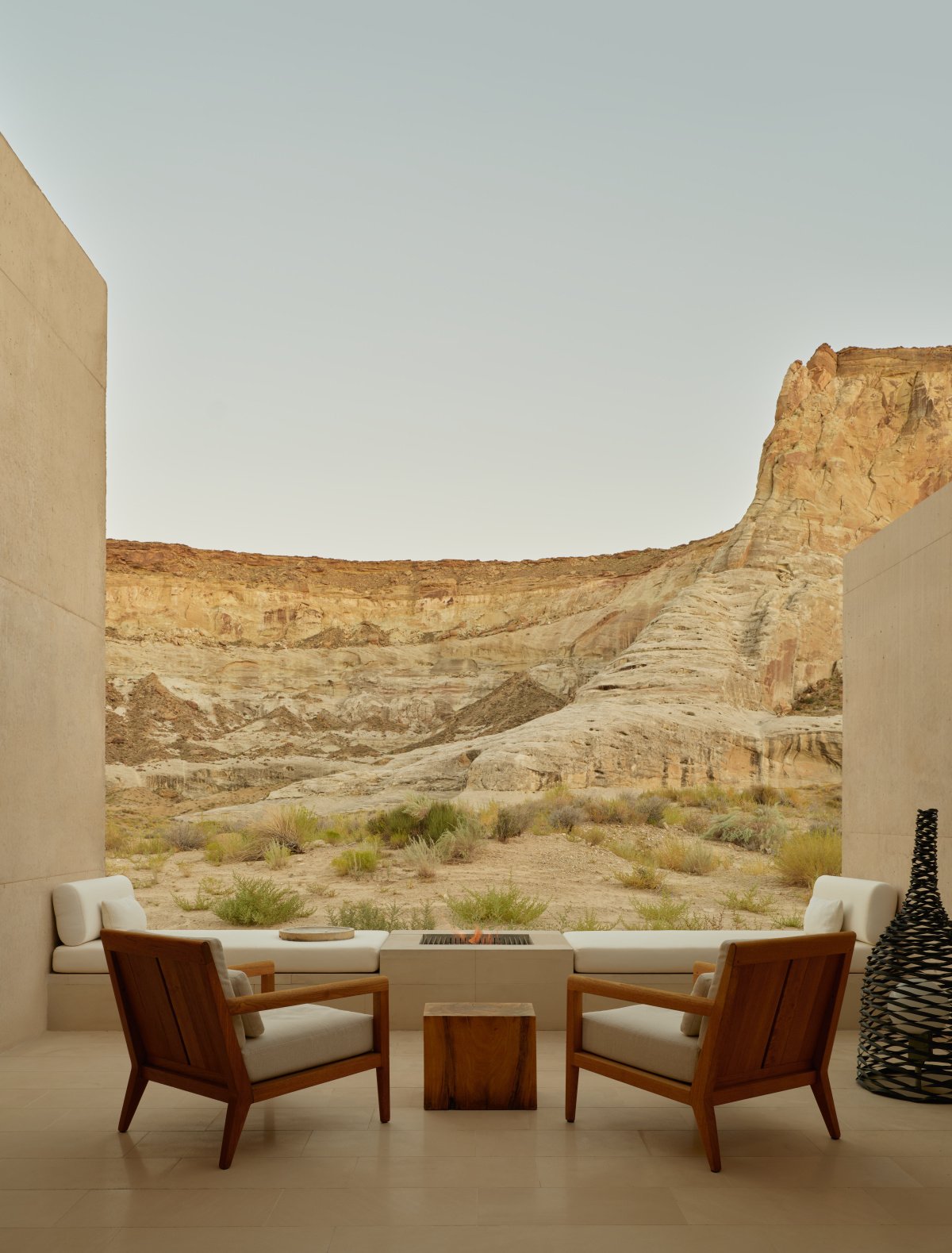 The elegant interior of a Girijaala Suite at Amangiri, featuring a king-size bed and views of the mountain ridge.