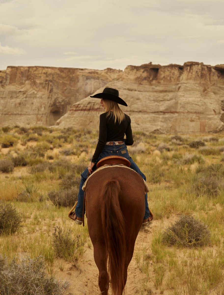 A guest on a horseback riding trail, exploring the property around Amangiri resort.