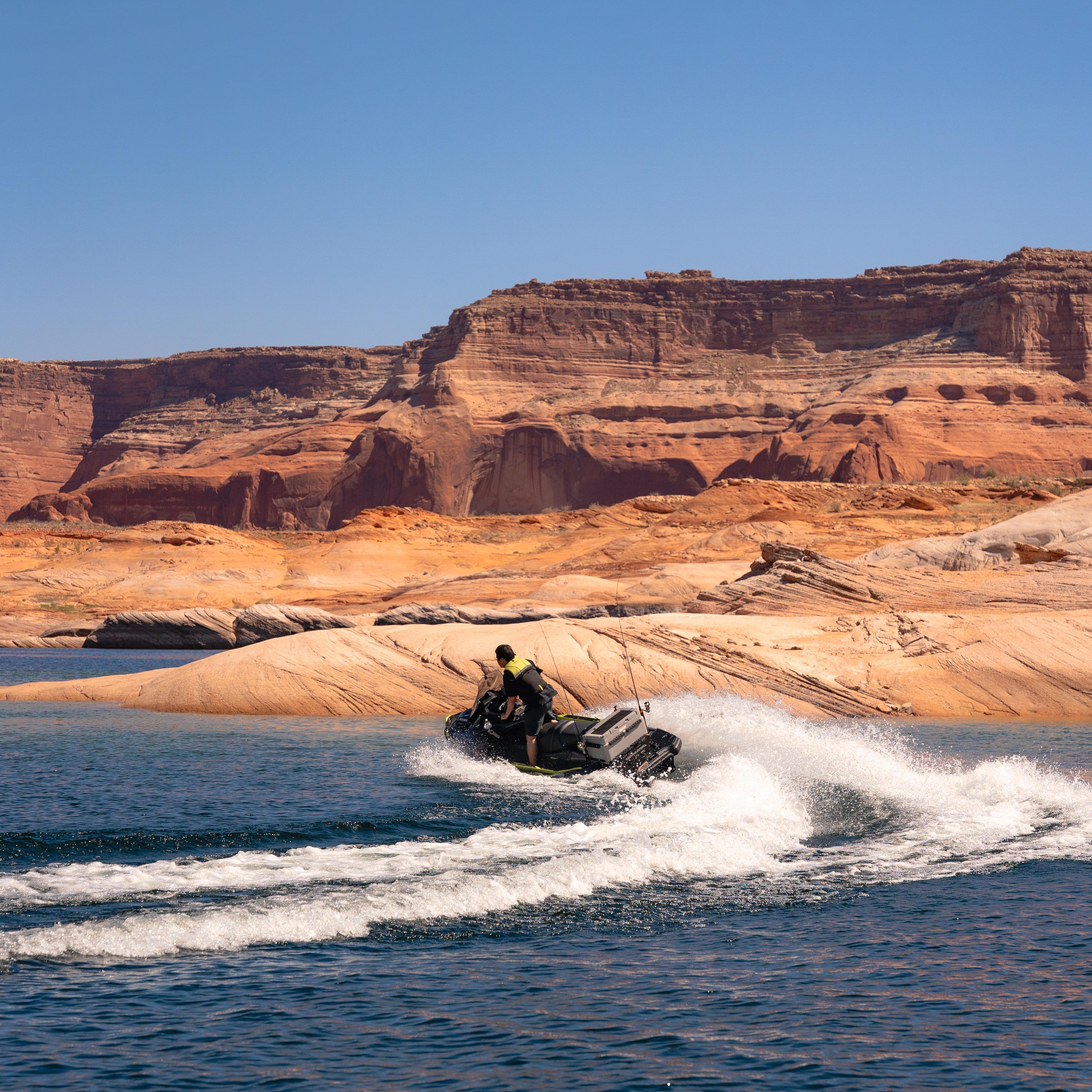 A guest enjoying a jet ski adventure on the brilliant blue waters of Lake Powell.