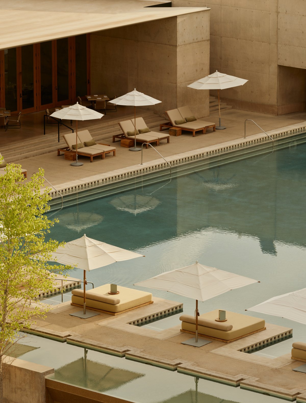 The iconic swimming pool at Amangiri resort, wrapping around a dramatic sandstone mesa.