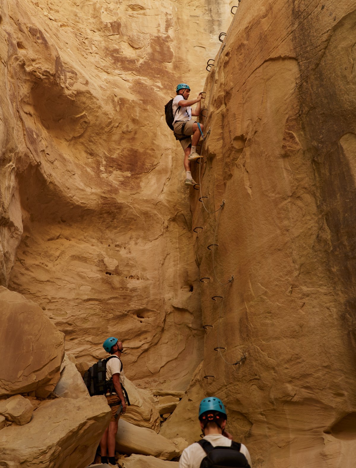 Guests challenging themselves on the via ferrata climbing routes on Amangiri's sandstone mesas.