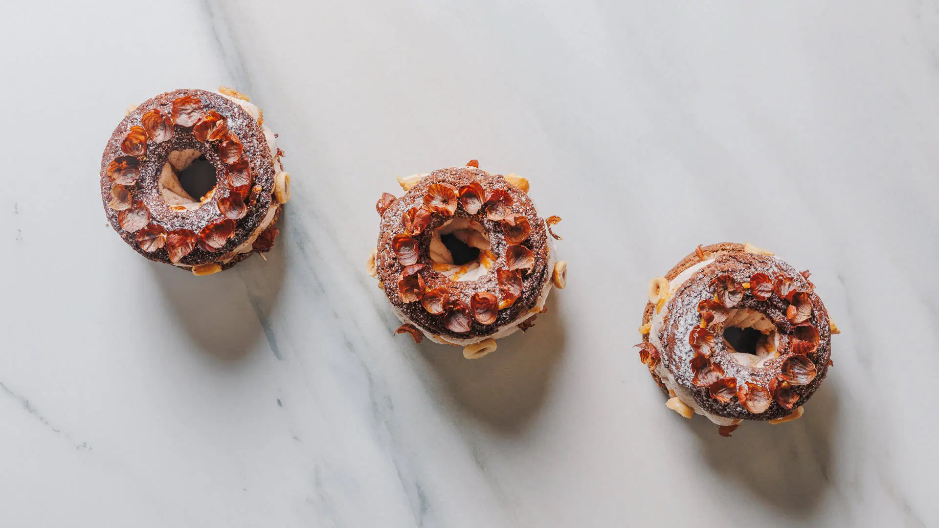 A display of signature multi-layer cakes and entremets from Les Desserts boutique.