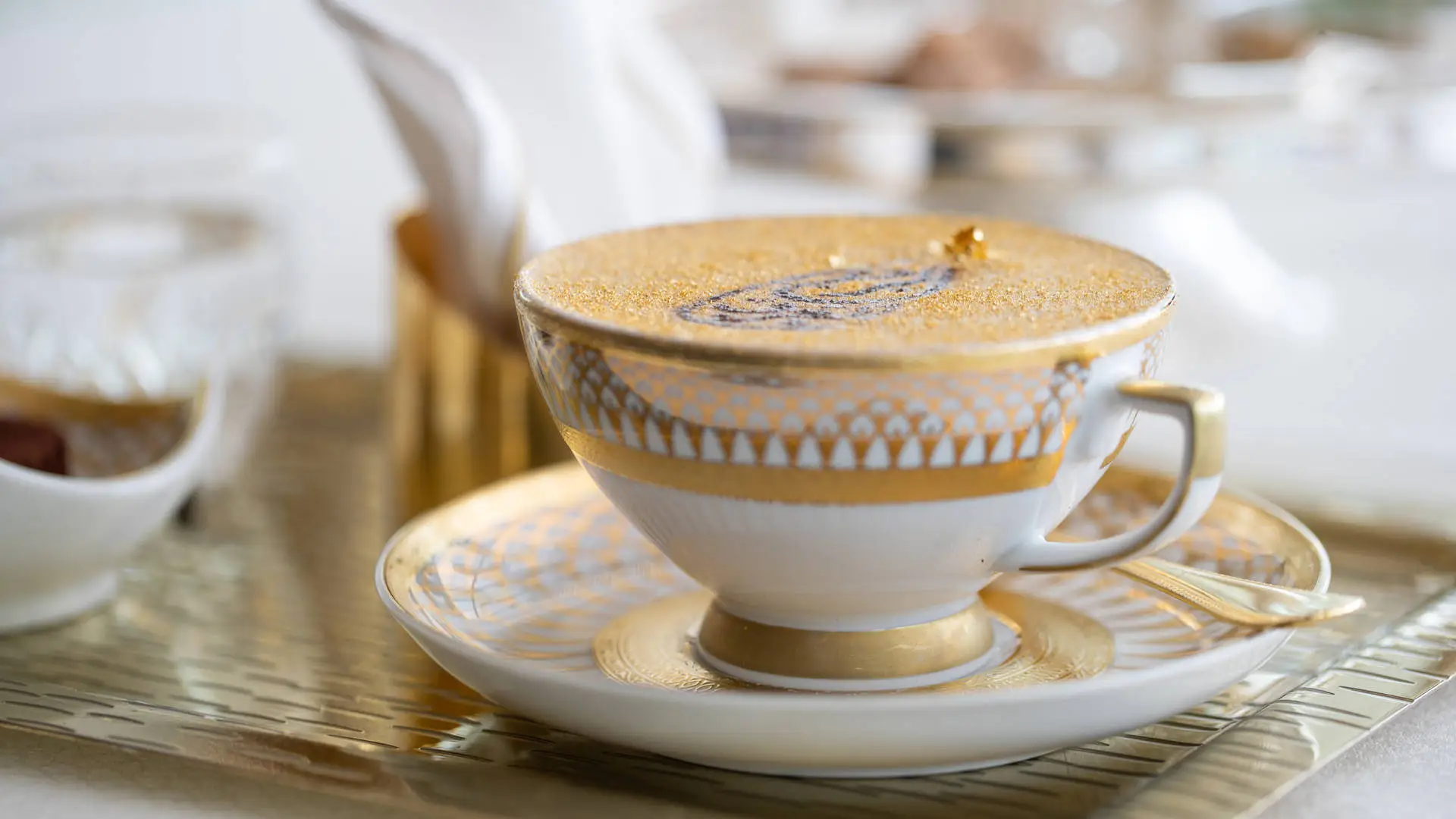 The iconic Burj Al Arab Gold Cappuccino, served with a delicate pastry.