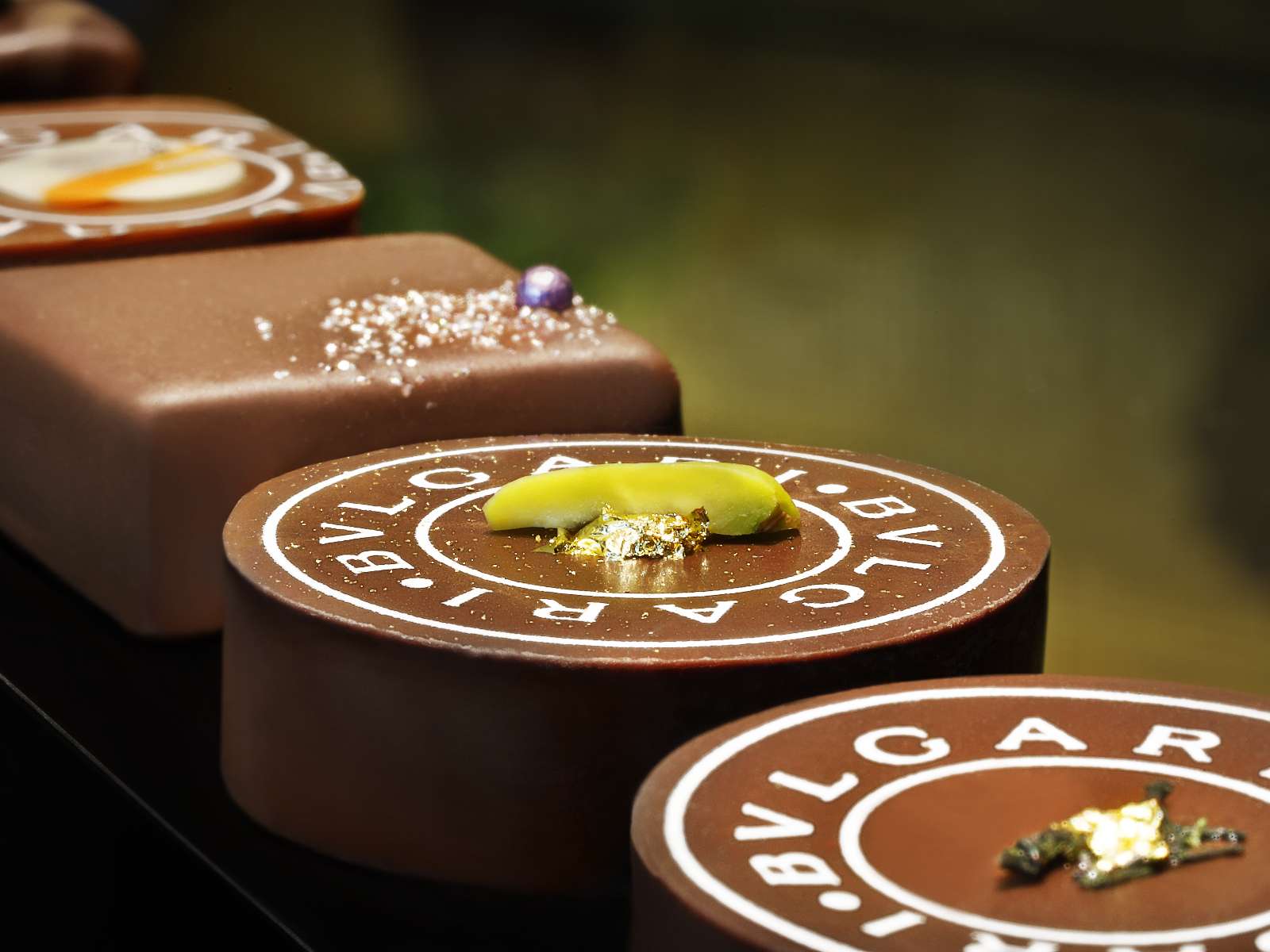 Handcrafted chocolate gems at Il Cioccolato, where Bvlgari's jewelry artistry meets chocolate making.